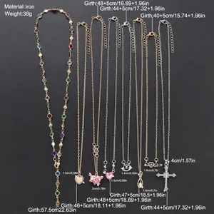 Set de 9 collares dorados y plateados con colgantes de corazón mariposa y cruz