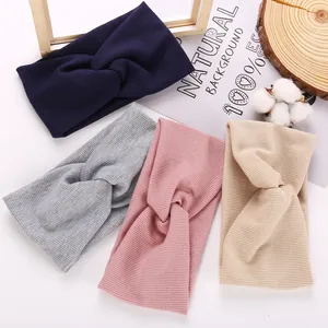 Flat lay of ribbed knit twist headbands in navy, grey, pink, and beige colors