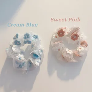 Elegant organza scrunchies in cream blue and sweet pink with delicate floral embroidery