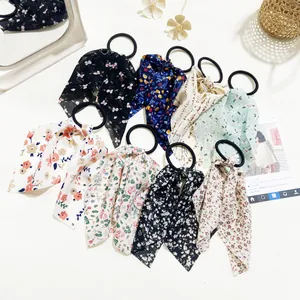 Flat lay of colorful floral chiffon bow hair ties set with various elegant patterns