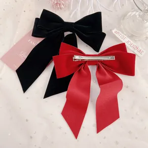 Elegant large velvet bow hair clips in red and black colors with long ribbon design