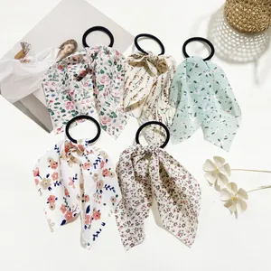 Detailed view of 5-piece floral bow hair scrunchies set in various pastel patterns