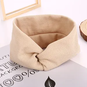 Minimalist beige ribbed knit criss-cross headband for women with a vintage aesthetic