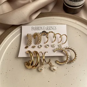 Detail of 9-piece gold earring set with pearls and crystals on fashion display card