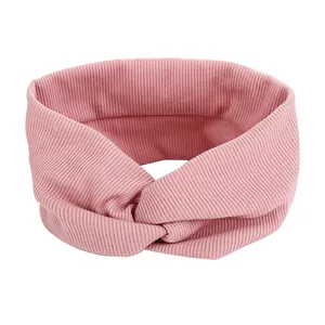 Pink ribbed knit headband with stylish cross knot design for women's daily hair styling