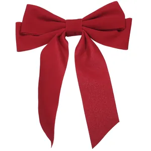 Elegant red velvet bow hair clip with long ribbons for women, minimalist hair accessory