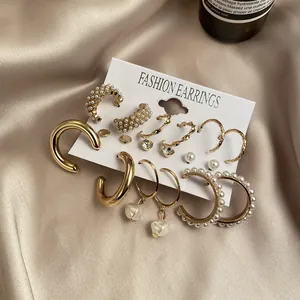 9-piece gold pearl earring set with French vintage hoops and creative charms on display