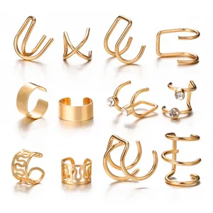 Detailed set of 12 gold ear cuffs featuring crossover and rhinestone designs