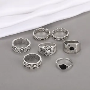 Macro view of vintage silver gothic ring set featuring spade A and heart patterns