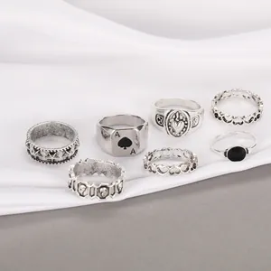 Detailed set of seven vintage gothic rings featuring spade, star, and skull motifs