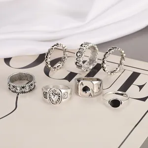 Detail of 7-piece retro silver ring set with ace of spades and heart motifs