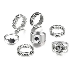Detailed view of 6-piece vintage silver rings set with ace of spades and heart motifs