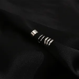 Macro shot of silver non-pierced ear cuff set on black silk background