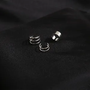 Detailed view of silver non-piercing ear cuff set with three minimalist metal designs
