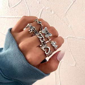 Retro 7-piece silver ring set featuring butterfly, heart, and cupid angel designs