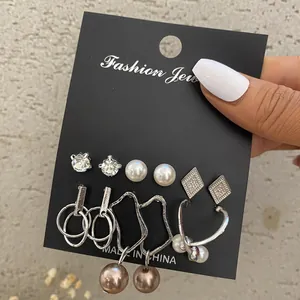Vintage pearl earring set with silver-tone hoops and butterfly pendants, 6 pairs displayed