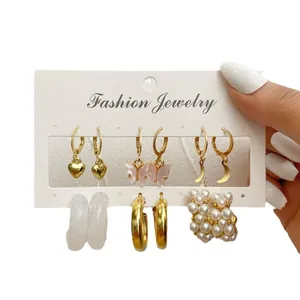 Set of six gold-tone vintage earrings with butterfly, heart, and pearl accents