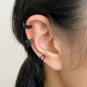 Three-piece matte black ear cuff set including textured and wide minimalist bands