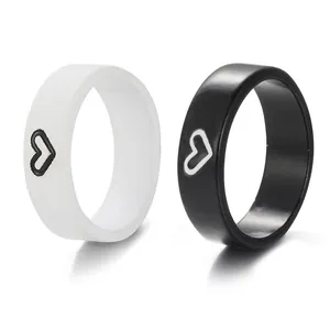 Minimalist black and white butterfly couple rings with contrasting heart design in resin