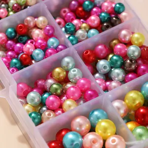 Vue macro de perles rondes colorées brillantes dans une boîte de rangement à compartiments