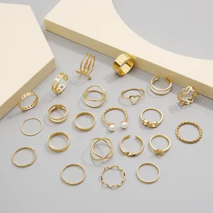 21-piece gold alloy ring set featuring butterfly, heart, and pearl designs on stone