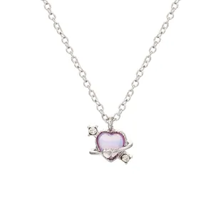 Detailed shot of heart planet pendant with purple glitter and sparkling cubic zirconia