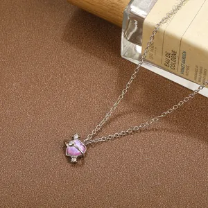 Macro shot of silver heart planet pendant with pink zircon and sparkling rhinestones