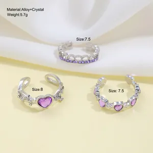 Detailed view of three purple crystal heart rings in alloy setting with size labels