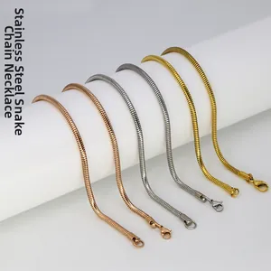 Detail of stainless steel snake chain necklaces with lobster clasp in gold and silver