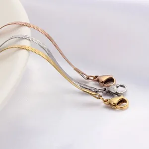 Detailed close-up of flat snake bone chain necklaces in gold, rose gold and silver finish