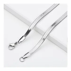 Close-up of silver herringbone chain necklace with secure lobster clasp and polished finish