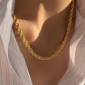 Close-up of golden rope chain necklace showing detailed spiral texture on model