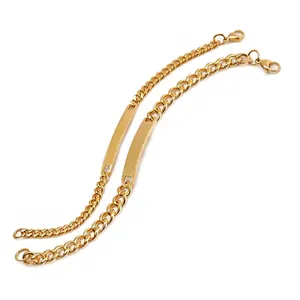 Detail of gold titanium steel curb chain ID bracelets with polished rectangular plates