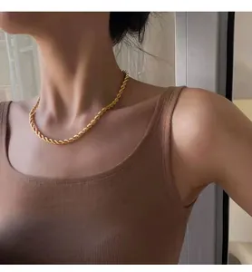 Close-up of a golden titanium steel rope chain necklace on model's neck for fashion styling