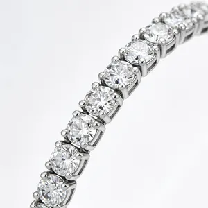 Macro view of four-prong set cubic zirconia on silver-toned tennis bracelet links