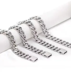 Polished silver stainless steel Cuban link chains in four sizes on a white stand