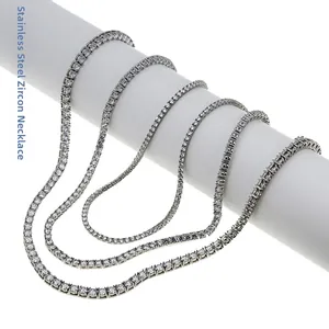 Detail showing multiple stainless steel tennis chains with zirconia stones on a white stand