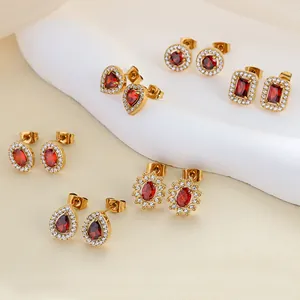 Close-up of six pairs of 18K gold plated earrings with red zircon and micro-pave crystals