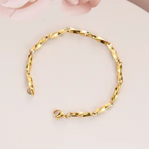 Detailed close-up of golden Mobius link chain bracelet with secure lobster clasp finish