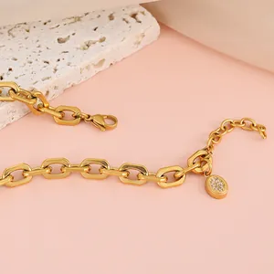 Detail of 18K gold stainless steel chain bracelet with micro-paved zircon oval pendant