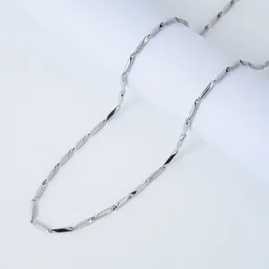 Detail view of silver stainless steel twisted rectangular links on a Cuban chain necklace