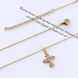Macro shot of gold cross pendant necklace featuring inlaid zircons and adjustable clasp