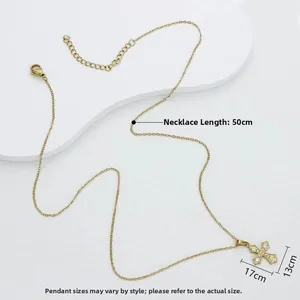 Detailed view of gold cross pendant with micro-pave zircons and 50cm lobster clasp chain
