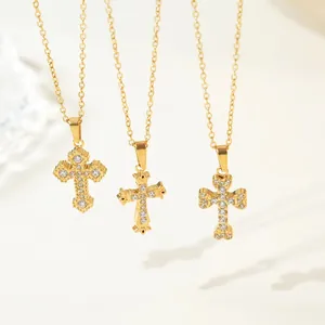 Detailed close-up of three gold-plated stainless steel cross necklaces with zircon