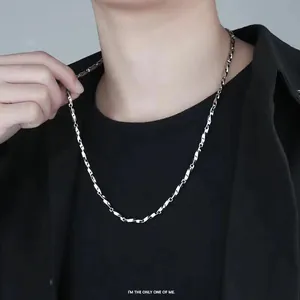 Detail of twisted Cuban link chain in stainless steel worn by a male model