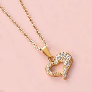 Macro shot of 18K gold plated hollow heart pendant necklace with shimmering cubic zirconia