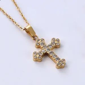 Macro view of gold-plated cross pendant necklace with sparkling micro-pave cubic zirconia