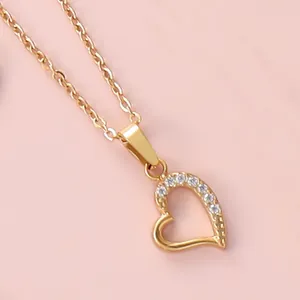 Macro shot of 18K gold plated heart necklace featuring half-pave sparkling zircon inlay