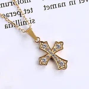 Detailed view of a gold cross pendant necklace featuring pavé set cubic zirconia accents