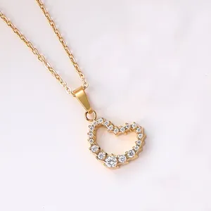 Macro shot of 18K gold heart pendant necklace featuring delicate pavé cubic zirconia